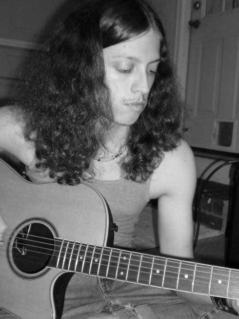 Playing acoustic guitar.